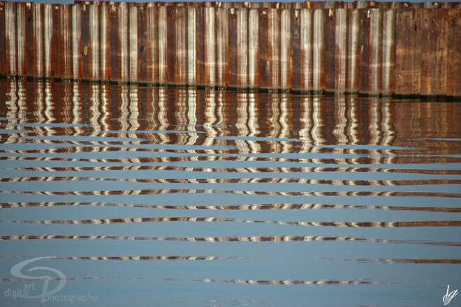 Water reflections top brown bottom blue color. The title of the picture is called - Reflections.